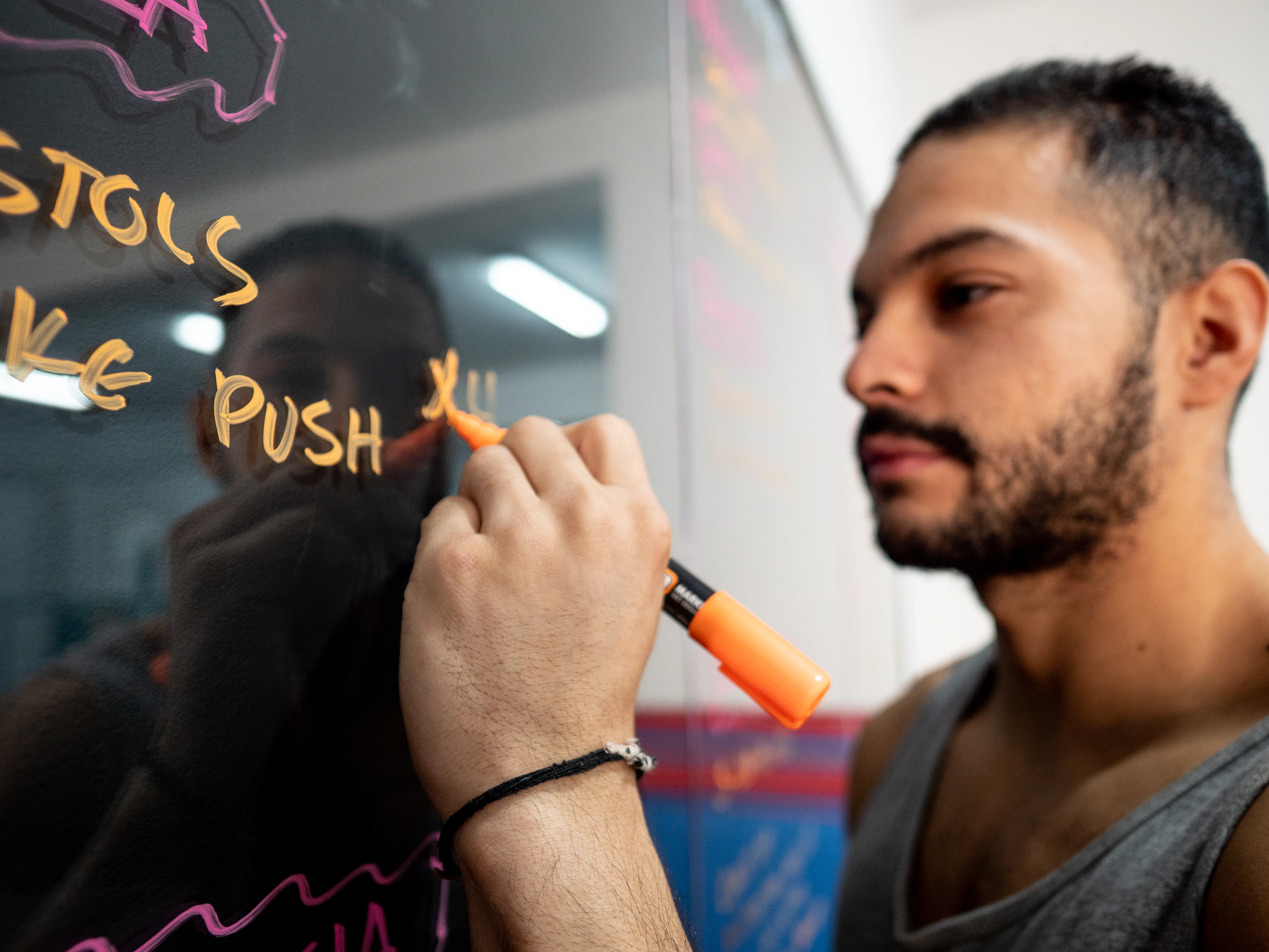 Jhonnatan escribiendo la planificación de entrenamiento en una pizarra